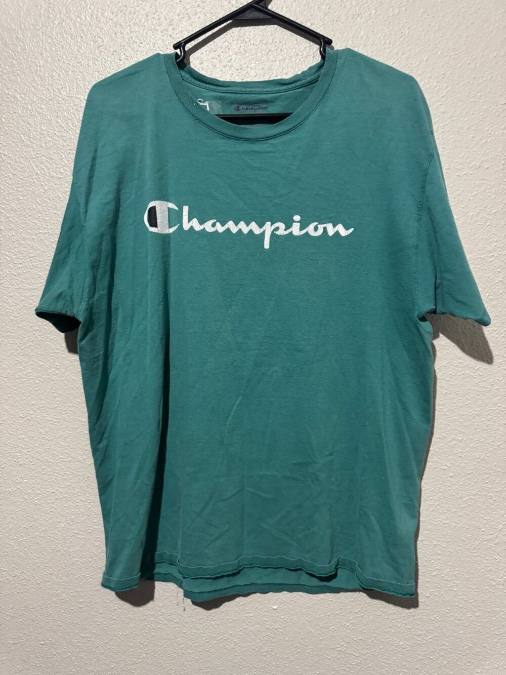 Champion short-sleeve crewneck T-shirt in teal with a large white script logo